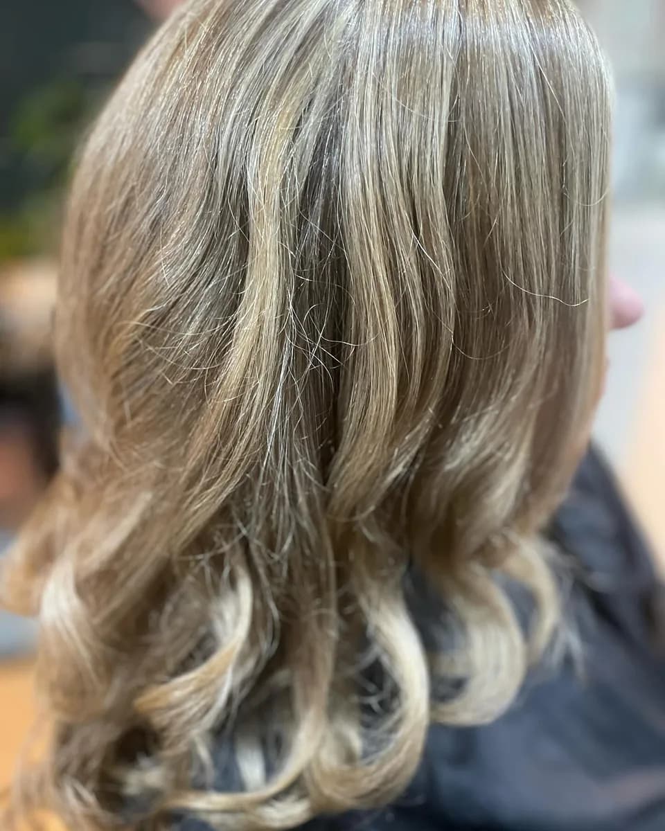 Blonde balayage curled and dressed out, soft through the lengths, finished at the AVM Hair studio